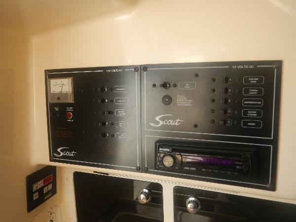 Slide: The Image of Control panel of 2001 Scout 282 Abaco boat with switches and stereo system. - 19
