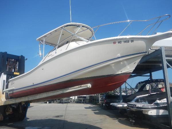 Slide: The Image of 2001 Scout 282 Abaco boat lifted on forklift at marina. - 28