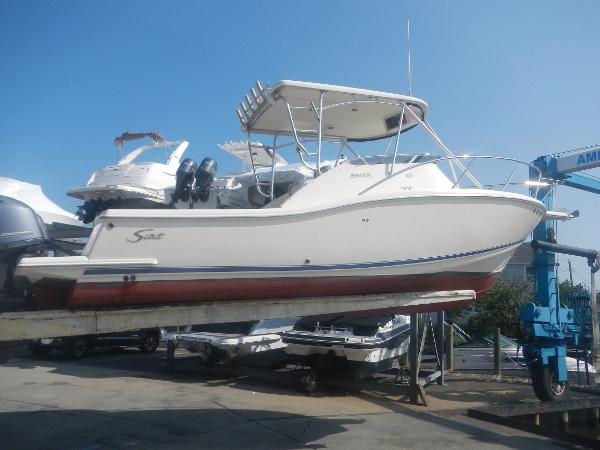 Slide: The Image of 2001 Scout 282 Abaco boat on lift, white hull, red bottom, dual engines. - 30