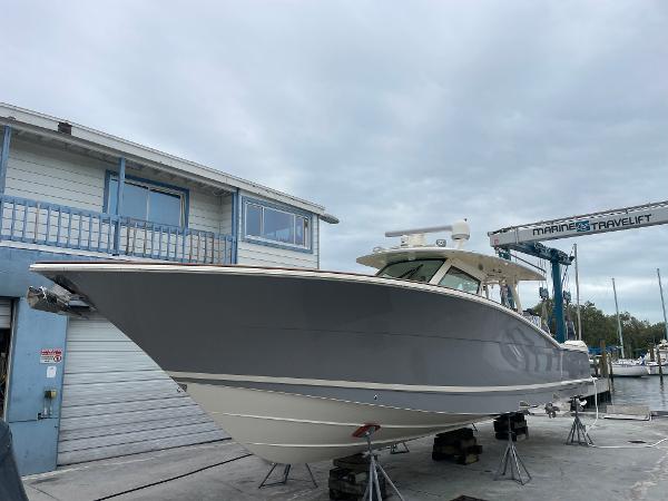 Slide: The Image of 2020 Scout 420 LXF boat on dry dock near marina building. - 1