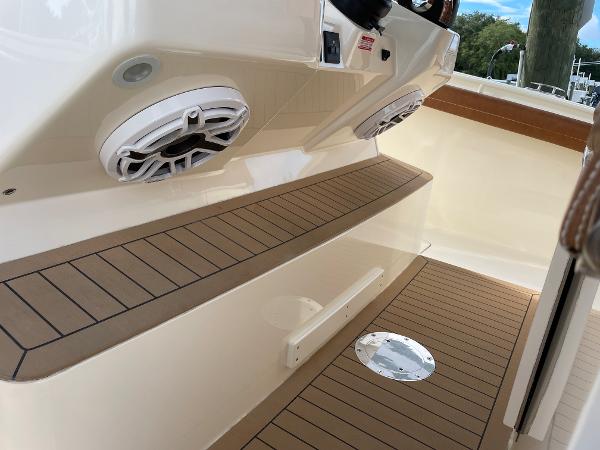 Slide: The Image of 2020 Scout 420 LXF boat interior with teak flooring and speakers. - 19