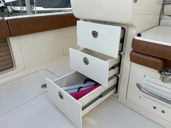 Slide: The Image of Open storage drawers on 2020 Scout 420 LXF boat interior. - 21