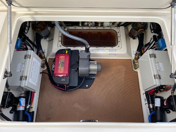 Slide: The Image of Engine compartment of 2020 Scout 420 LXF boat, showcasing electrical components and wiring. - 22