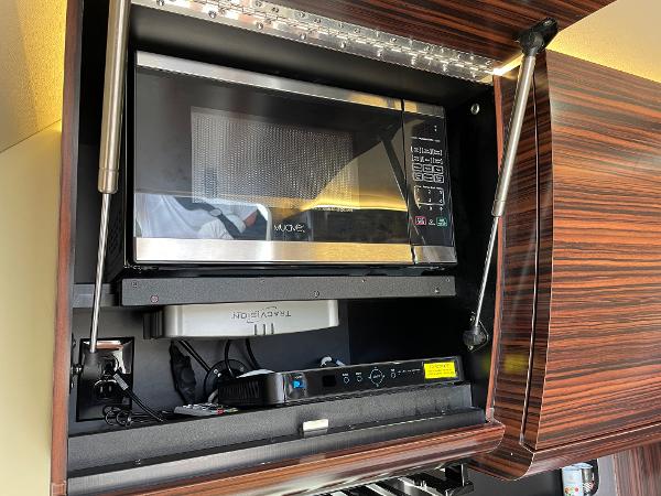 Slide: The Image of Microwave in 2020 Scout 420 LXF yacht's wooden cabinet interior. - 28