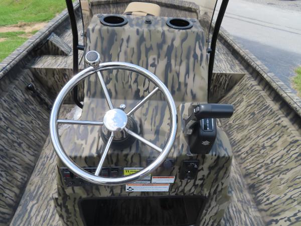 Slide: The Image of SeaArk 2072 FXT 2025 boat console with camouflage design and steering wheel. - 12