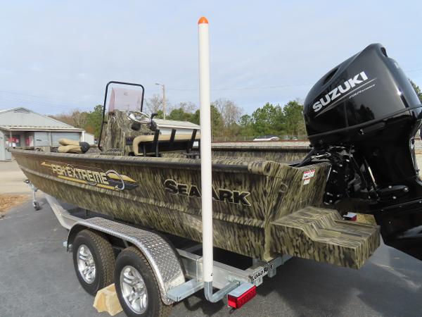Slide: The Image of 2025 SeaArk 2072 FXT boat with Suzuki outboard motor on a trailer. - 18