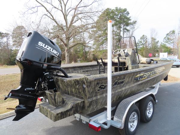 Slide: The Image of 2025 SeaArk 2072 FXT boat with Suzuki outboard motor on trailer. - 22