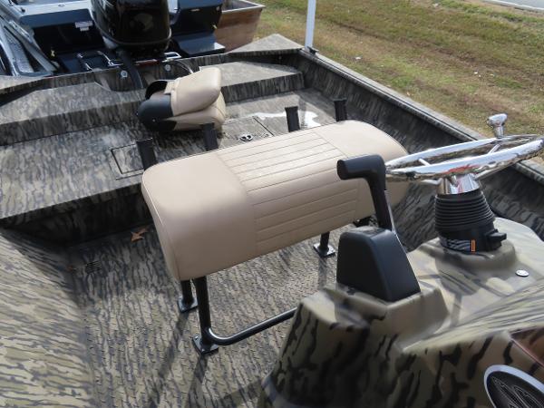 Slide: The Image of 2025 SeaArk 2072 FXT boat interior with camouflage design and beige seating. - 25