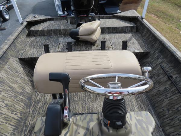 Slide: The Image of 2025 SeaArk 2072 FXT boat interior with steering wheel and beige seating. - 26