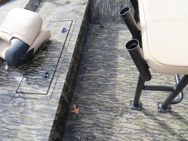Slide: The Image of Interior of 2025 SeaArk 2072 FXT boat with camo flooring and beige seating. - 27