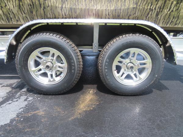 Slide: The Image of 2025 SeaArk 2072 FXT trailer wheels on asphalt. - 7