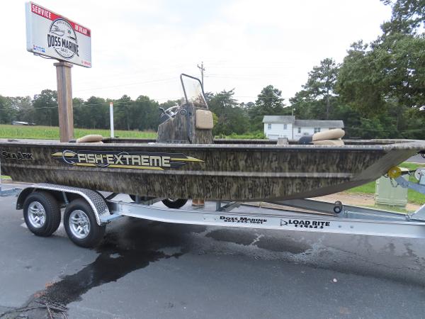 Slide: The Image of 2025 SeaArk 2072 FXT Fish Extreme boat on a trailer in a parking lot. - 9
