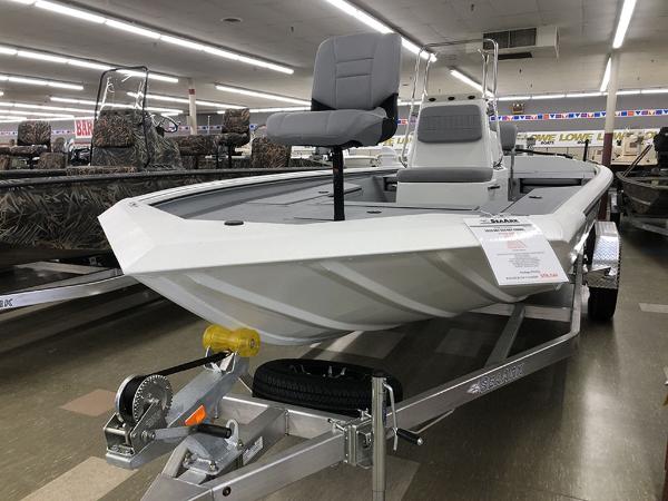 Slide: The Image of 2023 SeaArk BXT220 Bay Tunnel boat displayed indoors on a trailer. - 1