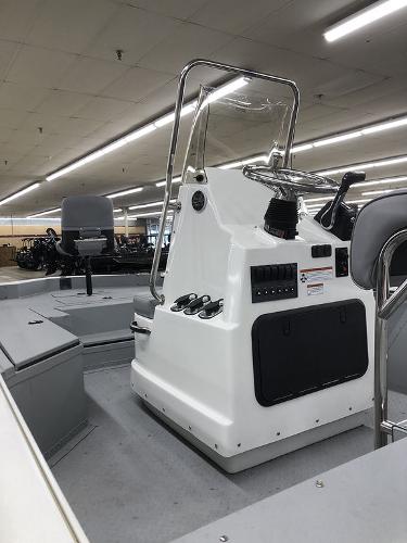 Slide: The Image of 2023 SeaArk BXT220 Bay Tunnel boat interior with control console and seating. - 5