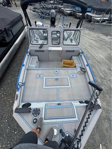 Slide: The Image of 2023 SeaArk Pro Cat 240 boat with spacious deck and modern features. - 11