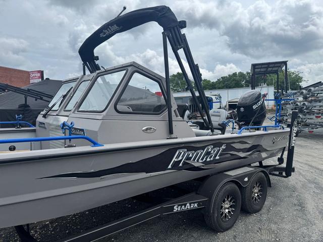 Slide: The Image of 2023 SeaArk Pro Cat 240 boat with Suzuki engine on a trailer, under cloudy skies. - 13