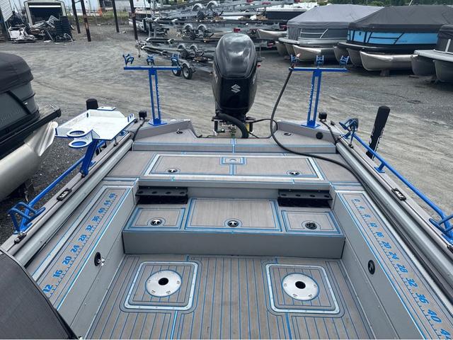 Slide: The Image of 2023 SeaArk Pro Cat 240 boat with fishing rod holders and Suzuki outboard motor. - 2