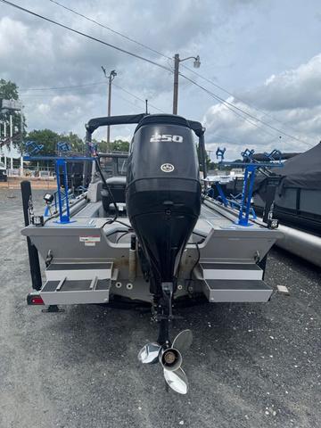 Slide: The Image of 2023 SeaArk Pro Cat 240 boat with powerful outboard motor, parked on gravel. - 3