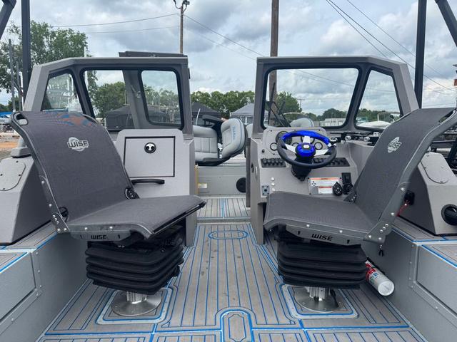 Slide: The Image of 2023 SeaArk Pro Cat 240 boat interior with dual Wise seats and steering console. - 4
