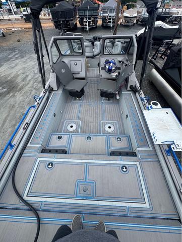 Slide: The Image of 2023 SeaArk Pro Cat 240 boat interior with spacious deck and seating. - 5