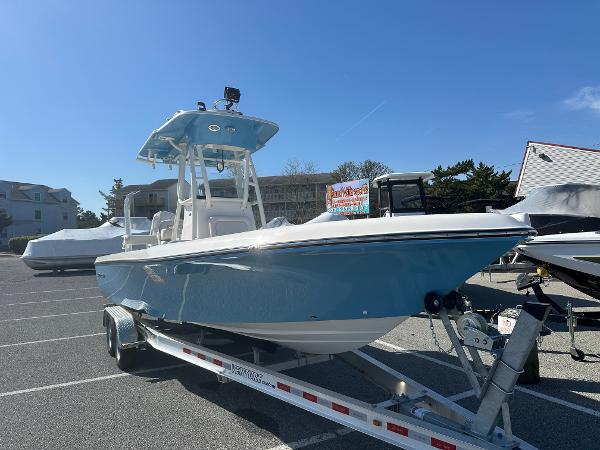 Slide: The Image of 2024 Sea Born FX25 Bay boat on trailer in parking lot. - 2