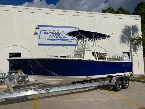 Slide: The Image of 2024 Sea Born LX24 boat on trailer at Moment Marine dealership. - 0