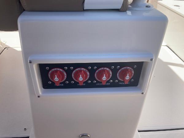 Slide: The Image of Control panel of a 2024 Sea Born LX24 boat with red switches. - 6