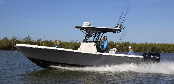 Slide: The Image of 2023 Sea Born LX26 boat cruising on water with three passengers. - 0
