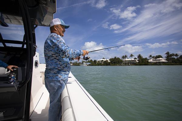 Slide: The Image of Man fishing on a 2023 Sea Born LX26 boat in a tropical setting. - 10