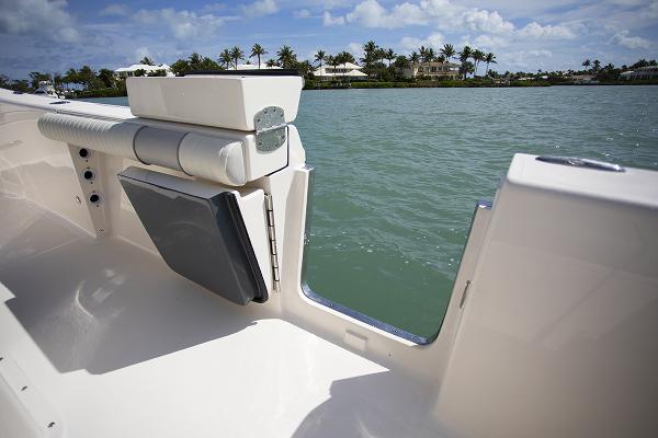 Slide: The Image of 2023 Sea Born LX26 boat interior with open side door, view of water and shoreline. - 12