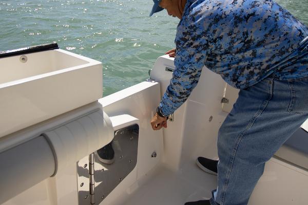 Slide: The Image of Man on 2023 Sea Born LX26 boat adjusting equipment. - 14