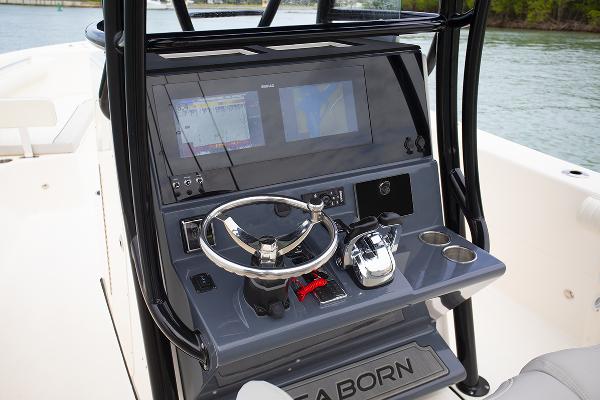 Slide: The Image of 2023 Sea Born LX26 boat dashboard with steering wheel and navigation screens. - 15