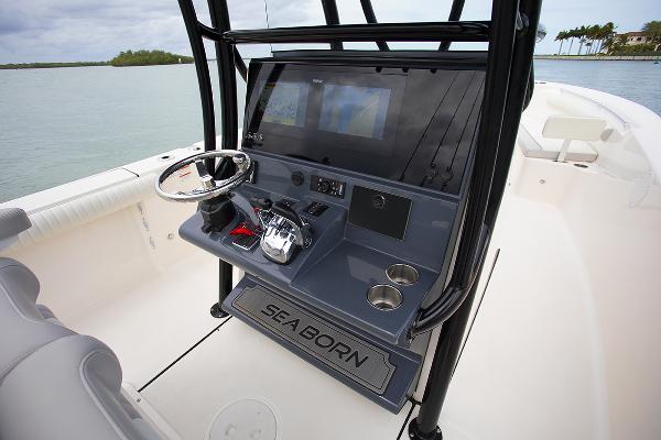 Slide: The Image of 2023 Sea Born LX26 boat console with steering wheel and navigation screens. - 16