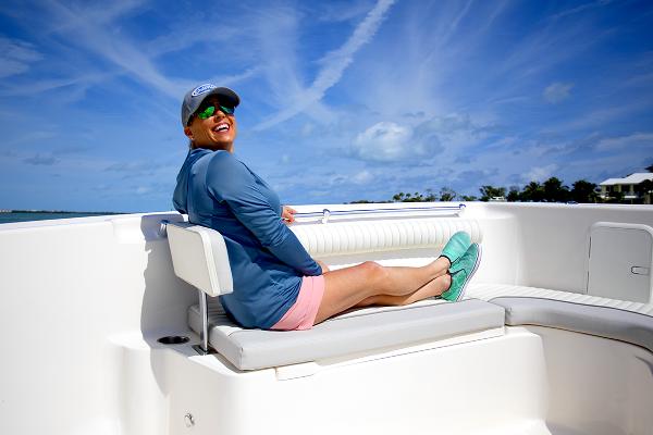 Slide: The Image of Person relaxing on a 2023 Sea Born LX26 boat under a clear blue sky. - 19