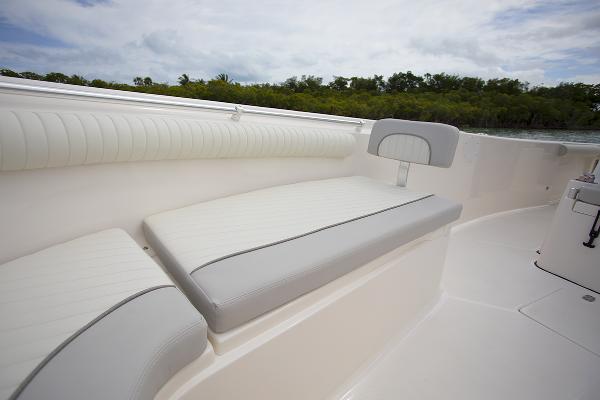 Slide: The Image of 2023 Sea Born LX26 boat interior with cushioned seating and scenic background. - 20