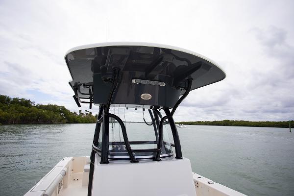 Slide: The Image of 2023 Sea Born LX26 boat on calm water with T-top and console. - 24