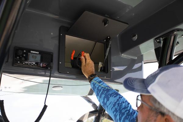 Slide: The Image of Man accessing storage compartment on 2023 Sea Born LX26 boat. - 26