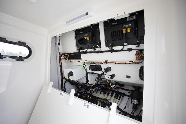 Slide: The Image of 2023 Sea Born LX26 boat electrical system compartment with wiring and components. - 28