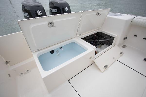 Slide: The Image of 2023 Sea Born LX26 boat with open storage compartments and Suzuki engines. - 7