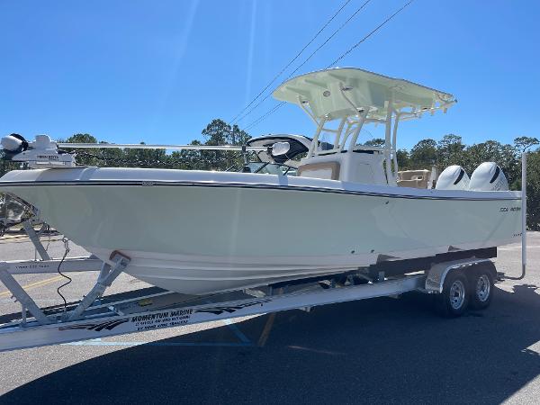 Slide: The Image of 2024 Sea Born LX 26 boat on trailer under clear blue sky. - 1