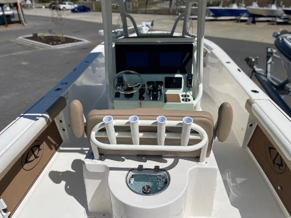 Slide: The Image of 2024 Sea Born LX 26 center console boat interior with helm and rod holders. - 3