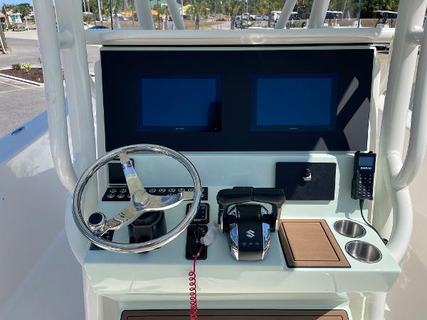 Slide: The Image of 2024 Sea Born LX 26 boat dashboard with dual screens and steering wheel. - 4