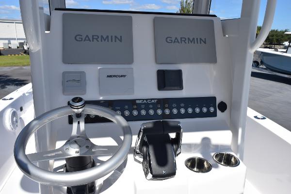 Slide: The Image of Control panel of 2025 Sea Cat 26 Hybrid Catamaran with Garmin displays and steering wheel. - 10