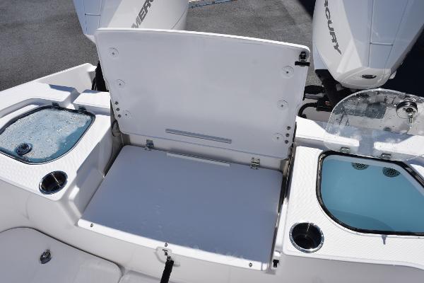 Slide: The Image of 2025 Sea Cat 26 Hybrid Catamaran with open storage compartment and dual Mercury engines. - 24