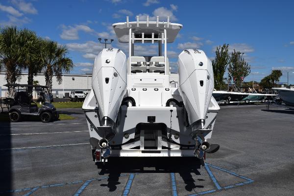 Slide: The Image of 2025 Sea Cat 26 Hybrid Catamaran with dual engines, parked outdoors under a clear sky. - 3