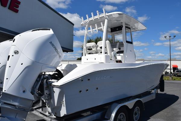 Slide: The Image of 2025 Sea Cat 26 Hybrid Catamaran with Mercury engine on trailer, under clear blue sky. - 5