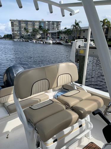 Slide: The Image of 2017 Sea Fox 226 Commander boat with beige seating, docked near waterfront condos. - 8