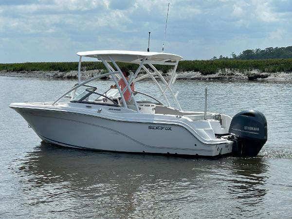 Slide: The Image of 2024 Sea Fox 226 Traveler boat on calm water with Yamaha outboard motor. - 2