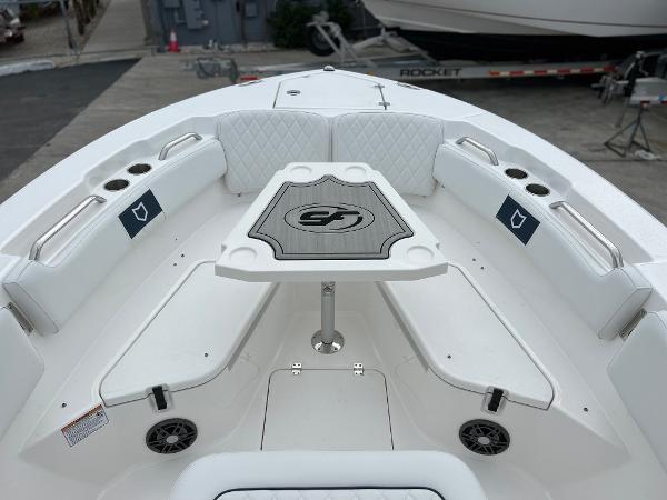 Slide: The Image of 2024 Sea Fox 228 Commander boat bow seating area with table and cup holders. - 11