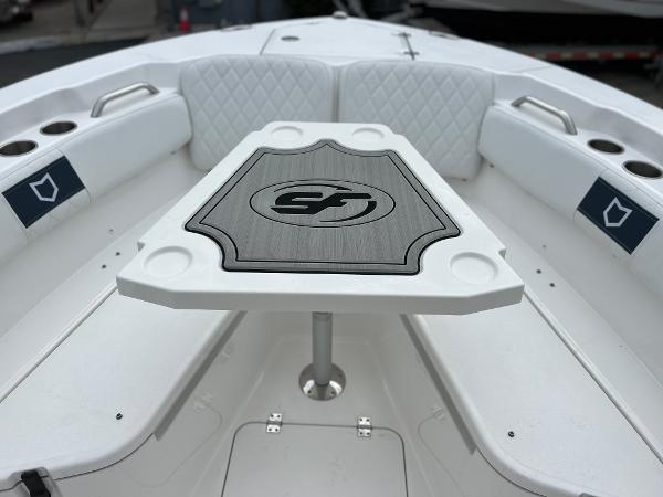 Slide: The Image of 2024 Sea Fox 228 Commander boat interior with table and cushioned seating. - 12